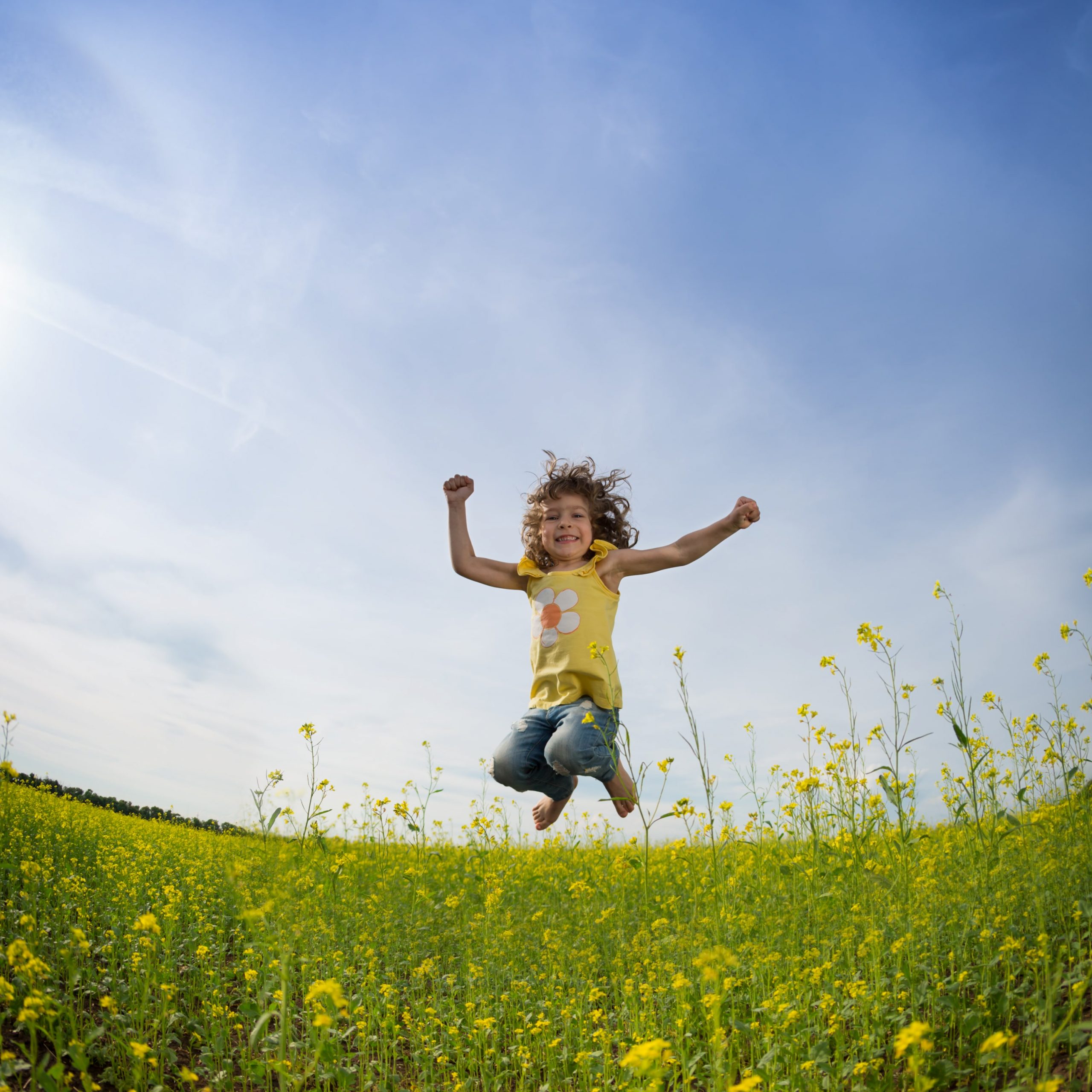 Beautiful little girl jumping for joy