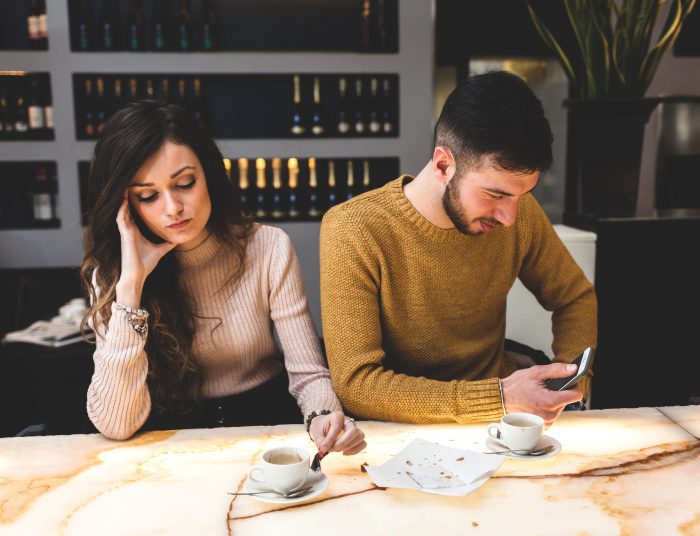 Young couple at coffee bar worried about unexplained infertility
